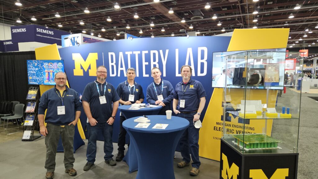 Group of men at Battery Lab booth at trade show